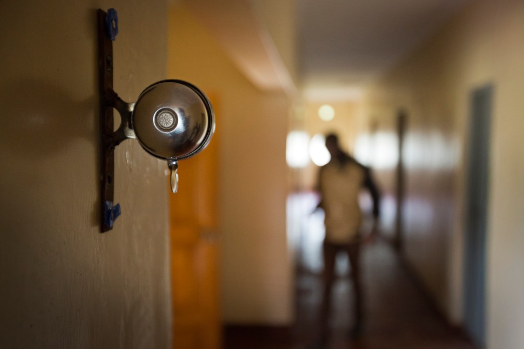 In this Jan. 30, 2016, photo a bicycle bell used to signal the athletes' 5 a.m. start of the day, hangs on the wall of the dormitory corridor at the Global Sports camp near the village of Kaptagat in western Kenya. At the high-altitude training camp in Kenya, star athletes turn their back on modernity and bling for a simple life of hard training and communal, egalitarian living. (AP Photo/Ben Curtis)