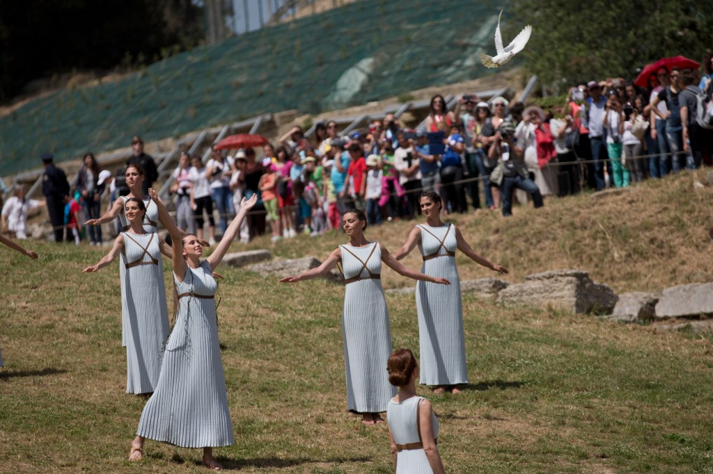 A priestess releases a white dove during the dress rehearsal for the lighting of the Rio Rio de Janeiro Olympics flame, in Ancient Olympia, southern Greece, on Wednesday, April 20, 2016. The meticulously choreographed ceremony will be repeated on Thursday in the ruined birthplace of the ancient Olympics in southern Greece, in the presence of top International Olympic Committee and Rio organizing officials. That will touch off a relay that will conclude with the Rio Games opening ceremony in August. (AP Photo/Petros Giannakouris)
