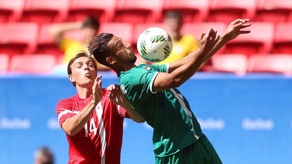 BRASILIA, BRAZIL - AUGUST 04: Nielsen Casper #14 of Denmark and Hammadi Ahmed #7 of Iraq vie for the ball at Mane Garrincha Stadium on August 4, 2016 in Brasilia, Brazil. (Photo by Celso Junior/Getty Images)
