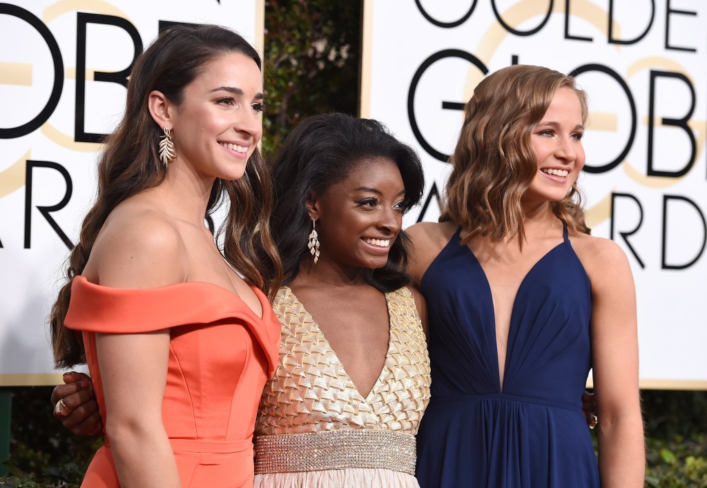 Aly Raisman, from left, Simone Biles and Madison Kocian arrive at the 74th annual Golden Globe Awards at the Beverly Hilton Hotel on Sunday, Jan. 8, 2017, in Beverly Hills, Calif. (Photo by Jordan Strauss/Invision/AP)