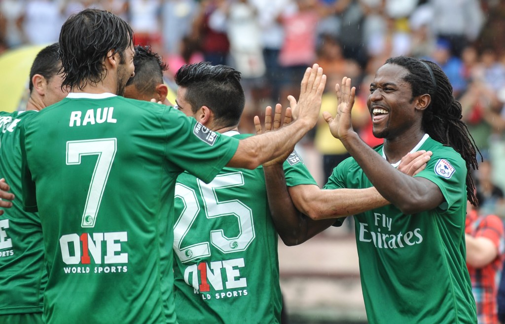New York Cosmos player Lucky Mkosana (R) greets teammate Spanish Raul Gonzalez (L) during a Cuba vs New York Cosmos friendly soccer match on June 2, 2015 at Pedro Marrero stadium in Havana. AFP PHOTO/YAMIL LAGE (Photo credit should read YAMIL LAGE/AFP/Getty Images)