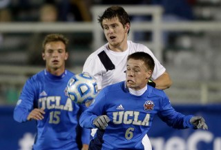 Providence's Mac Steeves, center, struggles for possession with UCLA's Jordan Vale (6) and Chase Gasper (15) during the first half of an NCAA College Cup semifinal soccer game in Cary, N.C., Friday, Dec. 12, 2014. (AP Photo/Gerry Broome)