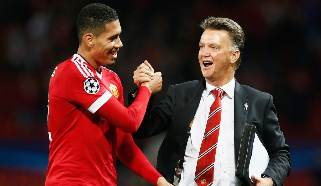 MANCHESTER, ENGLAND - SEPTEMBER 30:  Louis van Gaal manager of Manchester United celebrates victory with winning goalscorer Chris Smalling in the UEFA Champions League Group B match between Manchester United FC and VfL Wolfsburg at Old Trafford on September 30, 2015 in Manchester, United Kingdom.  (Photo by Dean Mouhtaropoulos/Getty Images)
