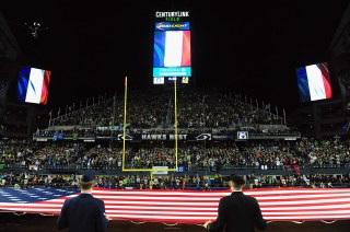 SEATTLE, WA - NOVEMBER 15: French flags are displayed alongside the American flag in honor of the victims of the recent terrorist attacks in Paris prior to the game between the Seattle Seahawks and the Arizona Cardinals at CenturyLink Field on November 15, 2015 in Seattle, Washington. (Photo by Steve Dykes/Getty Images)
