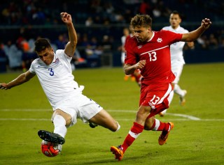 KANSAS CITY, KS - OCTOBER 01: Michael Petrasso #13 of Canada and Matt Miazga #3 of the USA compete for the ball during the 2015 CONCACAF Olympic Qualifying match at Sporting Park on October 1, 2015 in Kansas City, Kansas. (Photo by Jamie Squire/Getty Images)