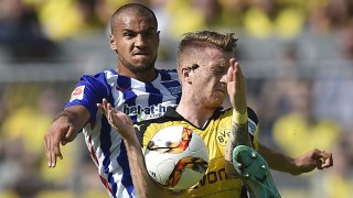 Dortmund's Marco Reus, right, and Berlin's John Anthony Brooks challenge for the ball during the German Bundesliga soccer match between Borussia Dortmund and Hertha BSC Berlin in Dortmund, Germany, Sunday, Aug. 30, 2015. (AP Photo/Martin Meissner)