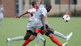 Georgetown defender Joshua Yaro (5) clears the ball past New Mexico midfielder Michael Calderon (11), back, during second-half action at Shaw Field on the Georgetown campus in Washington, D.C., Sunday, September 8, 2013. New Mexico defeated Georgetown in double overtime, 1-0. (Chuck Myers/MCT via Getty Images)