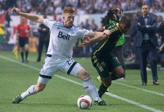 Vancouver Whitecaps FC Tim Parker (26) fights for control of the ball with Darlington Nagbe (6) of the Portland Timbers during the second half of MLS soccer action in Vancouver, British Columbia, Sunday, Nov. 8, 2015. (Jonathan Hayward/The Canadian Press via AP)