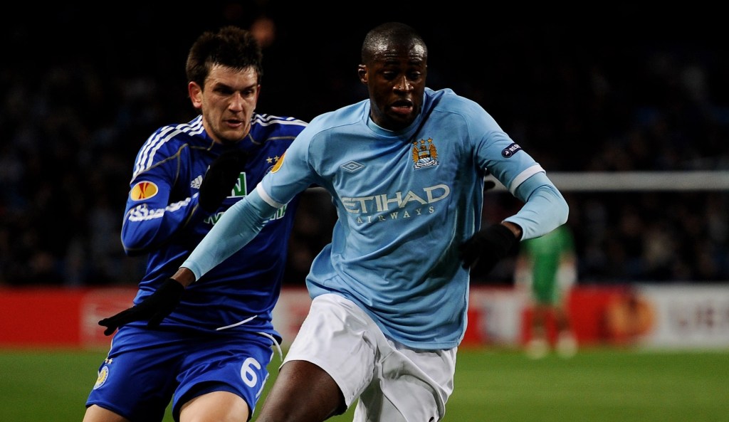 MANCHESTER, ENGLAND - MARCH 17: Yaya Toure of Manchester City holds off a challenge from Goran Popov of Dynamo Kiev during the UEFA Europa League round of 16 second leg match between Manchester City and Dynamo Kiev at City of Manchester Stadium on March 17, 2011 in Manchester, England. (Photo by Laurence Griffiths/Getty Images)