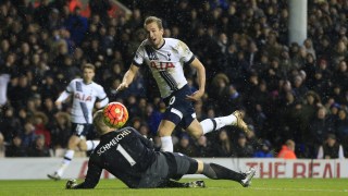 Tottenham Hotspurs Harry Kane, right, lifts the ball over Leicester Citys goalkeeper Kasper Schmeichel but fails to score during their English Premier League soccer match between Tottenham Hotspur and Leicester City at the White Hart Lane stadium in London Wednesday, Jan. 13, 2016. (AP Photo/Alastair Grant)