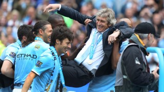 Manchester City's manager Manuel Pellegrini is carried by his players after the English Premier League soccer match between Manchester City and West Ham at the Etihad Stadium in Manchester, England, Sunday May 11, 2014. Manchester City won the Premier League for the second time in three seasons on Sunday, completing its campaign with a comfortable 2-0 victory over West Ham that lacked any of the drama of its previous title. (AP Photo/Jon Super)