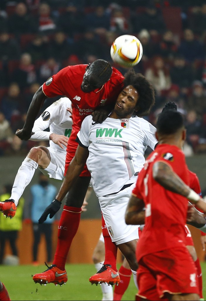Augsburg's Caiuby, right, and Liverpool's Mamadou Sakho challenge for the ball during the Europa League soccer match between FC Augsburg and FC Liverpool in Augsburg, southern Germany, Thursday, Feb. 18, 2016. (AP Photo/Matthias Schrader)
