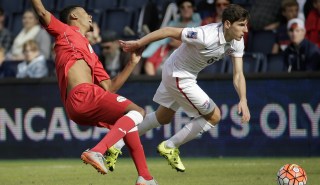 United States midfielder Emerson Hyndman (8) gets past Cuba defender Adrian Arturo Diz Pe during the first half of a CONCACAF men's Olympic qualifying soccer match Saturday, Oct. 3, 2015, in Kansas City, Kan. (AP Photo/Charlie Riedel)