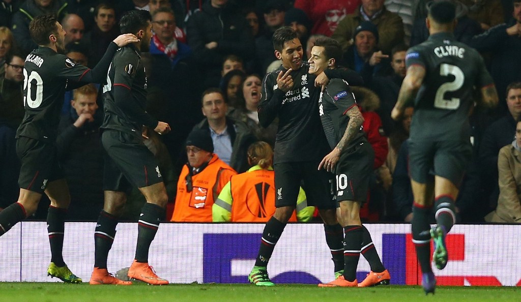 MANCHESTER, ENGLAND - MARCH 17: Philippe Coutinho of Liverpool (10) celebrates with team mates as he scores their first goal during the UEFA Europa League round of 16, second leg match between Manchester United and Liverpool at Old Trafford on March 17, 2016 in Manchester, England. (Photo by Clive Brunskill/Getty Images)