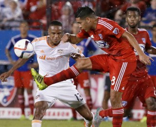 FC Dallas midfielder Victor Ulloa (8) kicks the ball in front of Houston Dynamo midfielder Ricardo Clark (13) during the second half of an MLS soccer game in Frisco, Texas, Friday, June 26, 2015. Dallas won 2-0. (AP Photo/LM Otero)