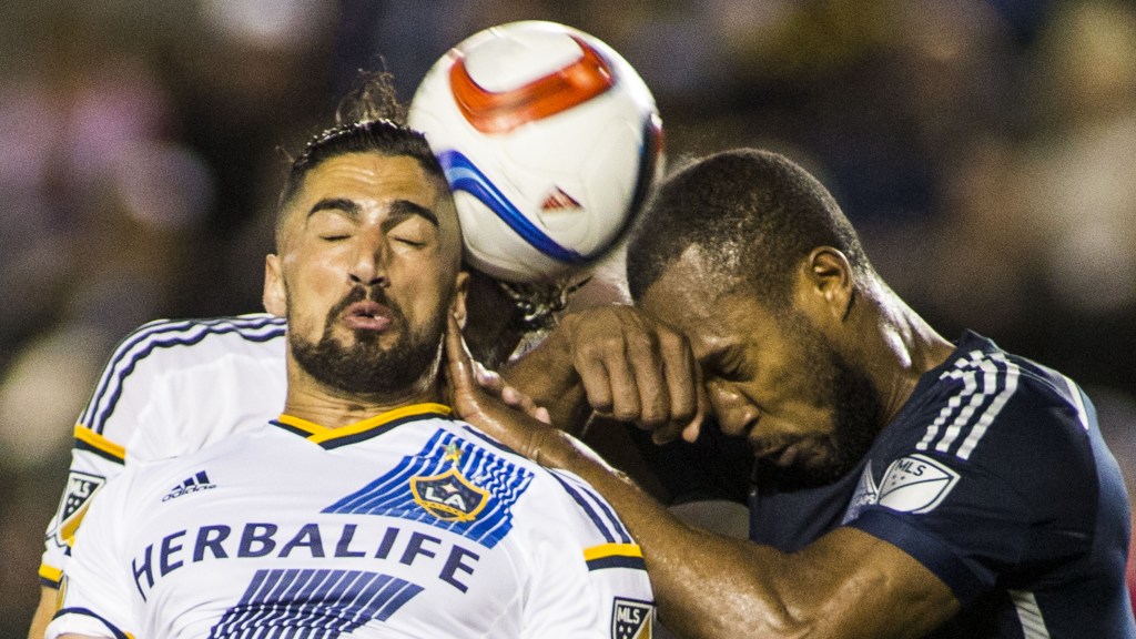 Los Angeles Galaxy midfielder Sebastian Lletget, left, and Vancouver Whitecaps defender Kendall Waston fight for a head ball in the second half of an MLS soccer game at StubHub Center in Carson, Calif., Saturday, June 6, 2015. The Whitecaps won 1-0. (AP Photo/Ringo H.W. Chiu)
