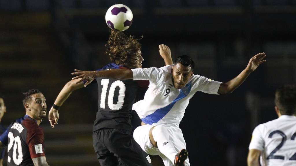 United States' Mix Diskerud, center left, and Guatemala's Gerson Tinoco go for the ball during a 2018 Russia World Cup qualifying soccer match at Mateo Flores Stadium in Guatemala City, Friday, March 25, 2016. (AP Photo/ Moises Castillo)