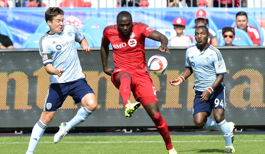 Sporting Kansas City's Matt Besler, left, vies for the ball with Toronto FC's Jozy Altidore as Sporting KC's Jimmy Medranda, right, chases during the first half of an MLS soccer match in Toronto on Saturday, Aug. 8, 2015. (Frank Gunn /The Canadian Press via AP) MANDATORY CREDIT