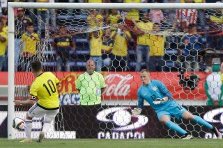 United States' goalkeeper Cody Cropper, right, fails to block Colombias Juan Quintero from scoring from the penalty spot during a U-23 first leg soccer match qualifier for the 2016 Rio Olympics at the Roberto Melendez Stadium in Barranquilla, Colombia, Friday, March 25, 2016. (AP Photo/Fernando Vergara)