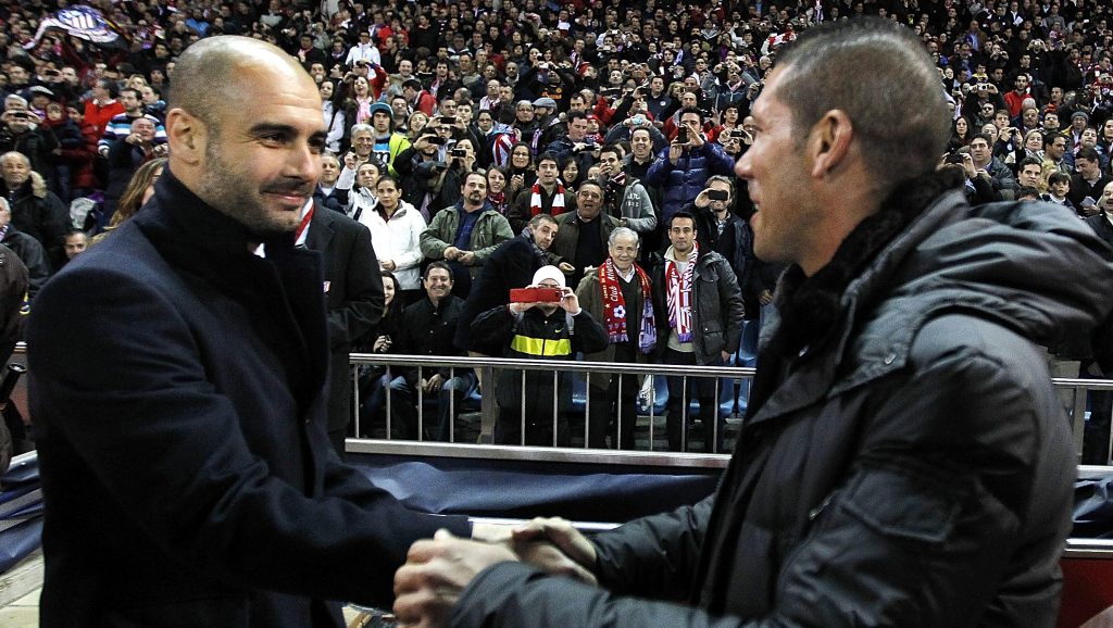 MADRID, SPAIN - FEBRUARY 26: Head coach Josep Guardiola (L) of Barcelona shakes hands with head coach Diego Simeone of Atletico Madrid prior of the La Liga match at Vicente Calderon Stadium on February 26, 2012 in Madrid, Spain. (Photo by Angel Martinez/Getty Images)