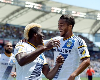 CARSON CA - AUGUST 9: Making his MLS debut Giovani Dos Santos #10 of the Los Angeles Galaxy congratulates Gyasi Zardes #11 after he scored a goal against Seattle Sounders during the first half at StubHub Center August 9, 2015, in Carson, California. (Photo by Kevork Djansezian/Getty Images)