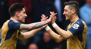 LONDON, UNITED KINGDOM - APRIL 09: Mesut Ozil (R) of Arsenal celebrates scoring his team's first goal with his team mate Hector Bellerin (L) during the Barclays Premier League match between West Ham United and Arsenal at the Boleyn Ground on April 9, 2016 in London, England. (Photo by Clive Rose/Getty Images)