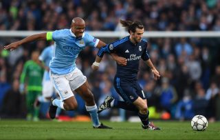 MANCHESTER, ENGLAND - APRIL 26: Gareth Bale of Real Madrid CF is challenged by Vincent Kompany of Manchester City during the UEFA Champions League Semi Final first leg match between Manchester City FC and Real Madrid at the Etihad Stadium on April 26, 2016 in Manchester, United Kingdom. (Photo by Shaun Botterill/Getty Images)