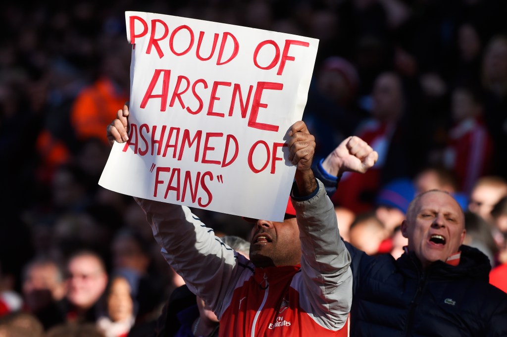 LONDON, ENGLAND - APRIL 30: An Arsenal supporter holds banner 'Proud of Arsene Ashamed of Fans' during the Barclays Premier League match between Arsenal and Norwich City at The Emirates Stadium on April 30, 2016 in London, England (Photo by Mike Hewitt/Getty Images)