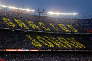 Fans hold up a mosaic of 90,000 cards with the slogan reading in Catalan: 'Thank you Johan' during a tribute to the late Dutch soccer star Johan Cruyff. (AP Photo/Emilio Morenatti)