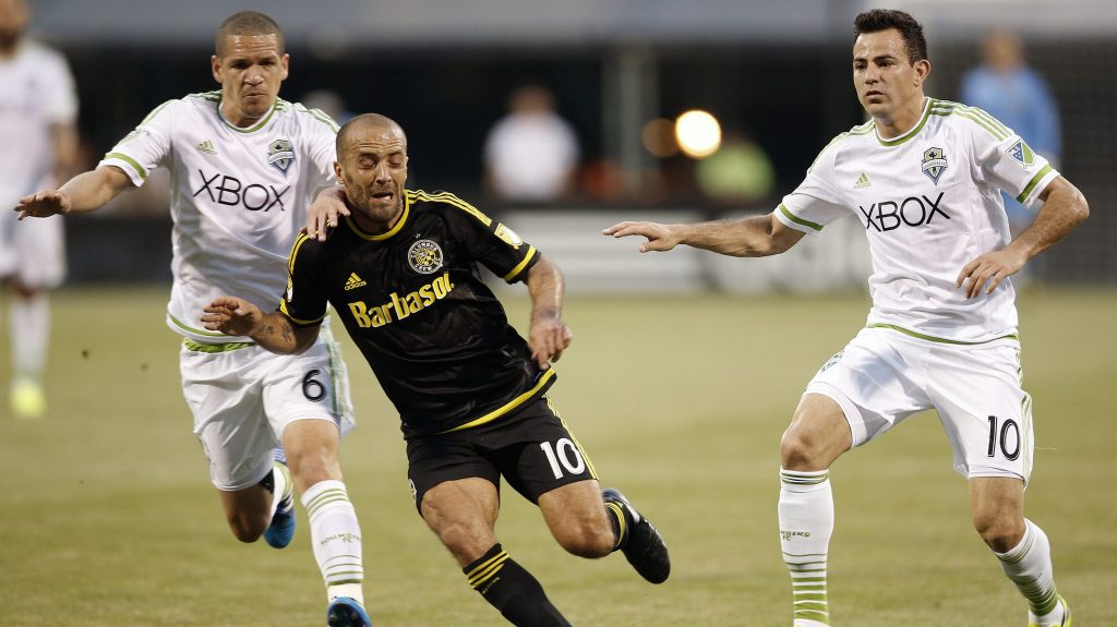 Columbus Crew forward Federico Higuain (10) battles for the ball against Seattle Sounders midfielders Osvaldo Alonso (6) and and Marco Pappa (10) during the first half of an MLS soccer game in Columbus, Ohio, on Saturday, May 9, 2015. (Kyle Robertson/Columbus Dispatch via AP)