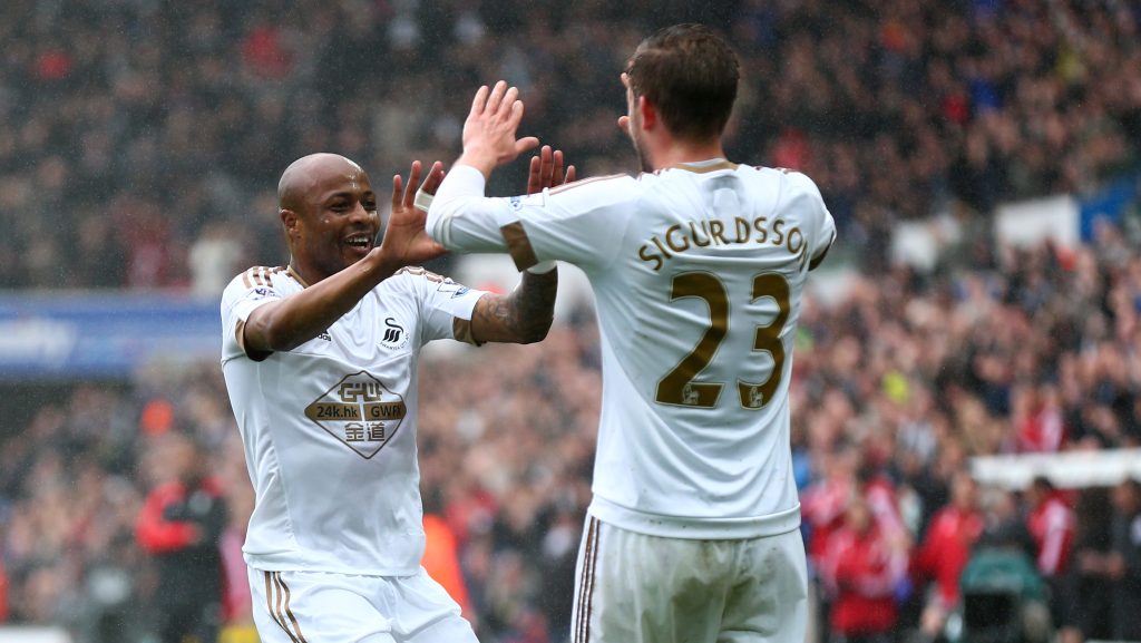 SWANSEA, WALES - MAY 01: Andre Ayew (L) of Swansea City celebrates scoring the opening goal with Gylfi Sigurdsson during the Barclays Premier League match between Swansea City and Liverpool at The Liberty Stadium on May 1, 2016 in Swansea, Wales. (Photo by Steve Bardens/Getty Images)
