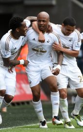 SWANSEA, WALES - MAY 15: Andre Ayew (2nd L) of Swansea City celebrates scoring his team's first goal with his team mates during the Barclays Premier League match between Swansea City and Manchester City at the Liberty Stadium on May 15, 2016 in Swansea, Wales. (Photo by Tom Dulat/Getty Images)