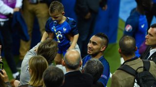 PARIS, FRANCE - JUNE 10: Dimitri Payet of France celebrate his team's win with his child after his team's 2-1 win in the UEFA Euro 2016 Group A match between France and Romania at Stade de France on June 10, 2016 in Paris, France. (Photo by Mike Hewitt/Getty Images)