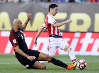 PHILADELPHIA, PA - JUNE 11: Miguel Almiron #17 of Paraguay tries to keep the ball as John Brooks #6 of United States slides in the first half during the Copa America Centenario Group C match at Lincoln Financial Field on June 11, 2016 in Philadelphia, Pennsylvania. (Photo by Elsa/Getty Images)