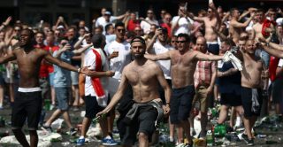 MARSEILLE, FRANCE - JUNE 11: England fans throw bottles and clash with police ahead of the game against Russia later today on June 11, 2016 in Marseille, France. Football fans from around Europe have descended on France for the UEFA Euro 2016 football tournament. (Photo by Carl Court/Getty Images)