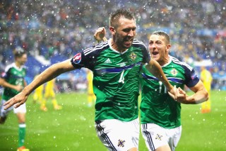 LYON, FRANCE - JUNE 16: Gareth McAuley (L) of Northern Ireland celebrates scoring his team's first goal with his team mate Conor Washington (R) during the UEFA EURO 2016 Group C match between Ukraine and Northern Ireland at Stade des Lumieres on June 16, 2016 in Lyon, France. (Photo by Clive Brunskill/Getty Images)