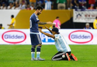 HOUSTON, TX - JUNE 21: Lionel Messi #10 of Argentina interacts with a fan who ran onto the field prior to the start of the second half during a 2016 Copa America Centenario Semifinal match between Argentina and the United States at NRG Stadium on June 21, 2016 in Houston, Texas. (Photo by Bob Levey/Getty Images)