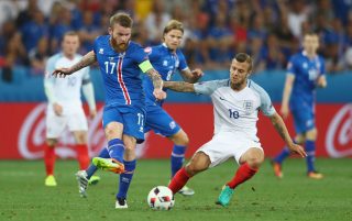 NICE, FRANCE - JUNE 27: Aron Gunnarsson of Iceland and Jack Wilshire of England compete for the ball during the UEFA EURO 2016 round of 16 match between England and Iceland at Allianz Riviera Stadium on June 27, 2016 in Nice, France. (Photo by Lars Baron/Getty Images)