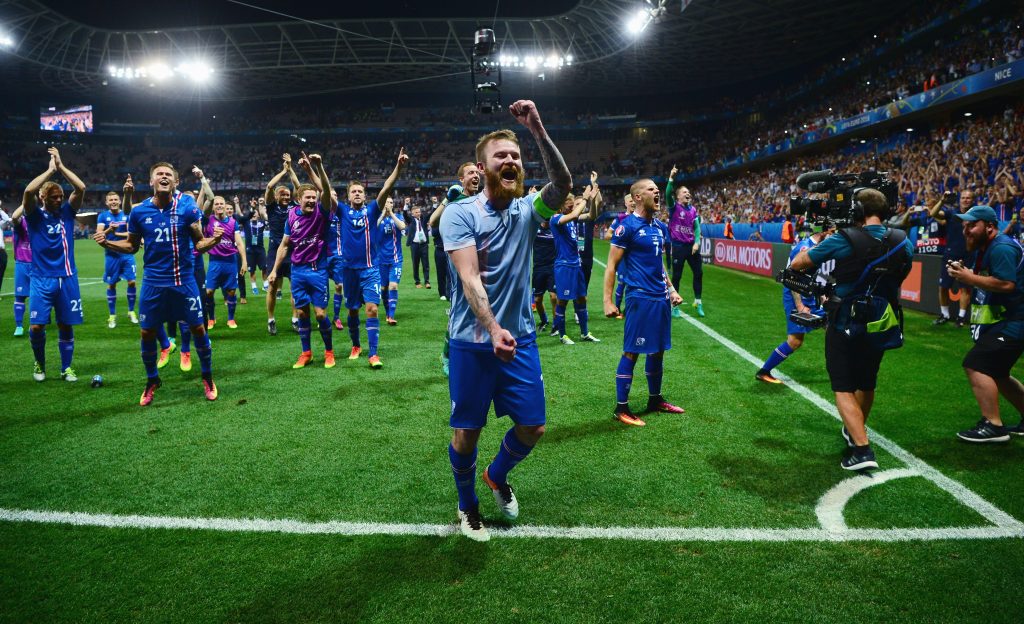 NICE, FRANCE - JUNE 27:  Aron Gunnarsson (C) and Iceland players celebrate their team's 2-1 win with supporters after the UEFA EURO 2016 round of 16 match between England and Iceland at Allianz Riviera Stadium on June 27, 2016 in Nice, France.  (Photo by Dan Mullan/Getty Images)