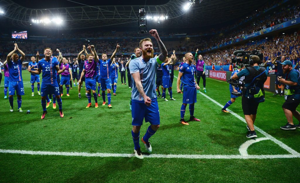 NICE, FRANCE - JUNE 27: Aron Gunnarsson (C) and Iceland players celebrate their team's 2-1 win with supporters after the UEFA EURO 2016 round of 16 match between England and Iceland at Allianz Riviera Stadium on June 27, 2016 in Nice, France. (Photo by Dan Mullan/Getty Images)