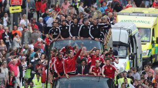 CARDIFF, WALES - JULY 08: Fans cheer as they line Westgate Street to welcome the Wales team home following their exit from the Euro 2016 championships, on July 8, 2016 in Cardiff, Wales. Wales' fairytale run ended on Wednesday after they were beaten 2-0 by Portugal in their Euro 2016 semi-final match (Photo by Matt Cardy/Getty Images)