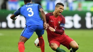 PARIS, FRANCE - JULY 10: Cristiano Ronaldo (R) of Portugal is challenged by Patrice Evra (L) of France during the UEFA EURO 2016 Final match between Portugal and France at Stade de France on July 10, 2016 in Paris, France. (Photo by Laurence Griffiths/Getty Images)
