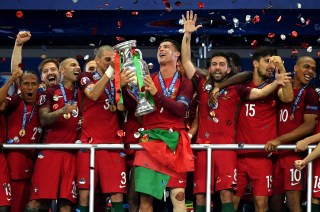 PARIS, FRANCE - JULY 10: Cristiano Ronaldo of Portugal (c) lifts the European Championship trophy after his side win 1-0 against France during the UEFA EURO 2016 Final match between Portugal and France at Stade de France on July 10, 2016 in Paris, France. (Photo by Matthias Hangst/Getty Images)