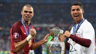 PARIS, FRANCE - JULY 10: Cristiano Ronaldo (R) and Pepe (L) of Portugal pose for photographs holding the Henri Delaunay trophy to celebrate after their 1-0 win against France in the UEFA EURO 2016 Final match between Portugal and France at Stade de France on July 10, 2016 in Paris, France. (Photo by Laurence Griffiths/Getty Images)