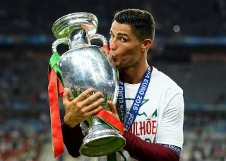 PARIS, FRANCE - JULY 10: Cristiano Ronaldo of Portugal kisses the Henri Delaunay trophy to celebrate after their 1-0 win against France in the UEFA EURO 2016 Final match between Portugal and France at Stade de France on July 10, 2016 in Paris, France. (Photo by Matthias Hangst/Getty Images)