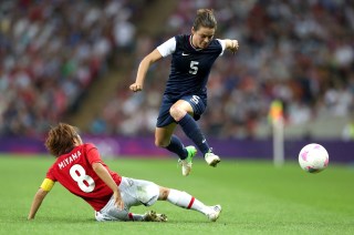 LONDON, ENGLAND - AUGUST 09: Kelley O'Hara #5 of United States moves the ball against Aya Miyama #8 of Japan in the second half during the Women's Football gold medal match on Day 13 of the London 2012 Olympic Games at Wembley Stadium on August 9, 2012 in London, England. (Photo by Julian Finney/Getty Images)