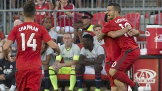 Toronto FC's Sebastian Giovinco, right, celebrates after scoring his team's second goal against the New England Revolution during first-half MLS soccer game action in Toronto, Saturday, Aug. 6, 2016. (Chris Young/The Canadian Press via AP)