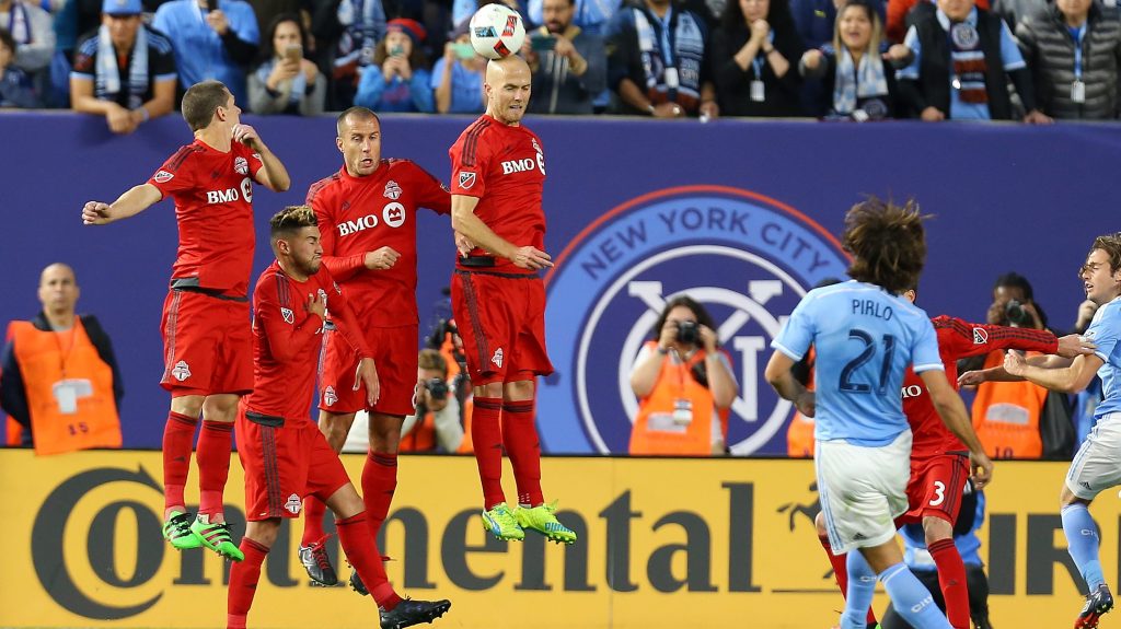 NEW YORK, NY - MARCH 13: Benoit Cheyrou #8 of Toronto FC defends Andrea Pirlo #21 of New York City FC free kick at Yankee Stadium on March 13, 2016 in the Bronx borough of New York City. (Photo by Mike Stobe/Getty Images)