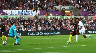 SWANSEA, WALES - SEPTEMBER 24: Raheem Sterling of Manchester City scores his sides third goal during the Premier League match between Swansea City and Manchester City at the Liberty Stadium on September 24, 2016 in Swansea, Wales. (Photo by Michael Steele/Getty Images)