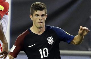 United States' Christian Pulisic (10) tries to moves the ball around Trinidad & Tobago's Andre Boucaud (14) during the first half of a CONCACAF World Cup qualifying soccer match, Tuesday, Sept. 6, 2016, in Jacksonville, Fla. (AP Photo/John Raoux)